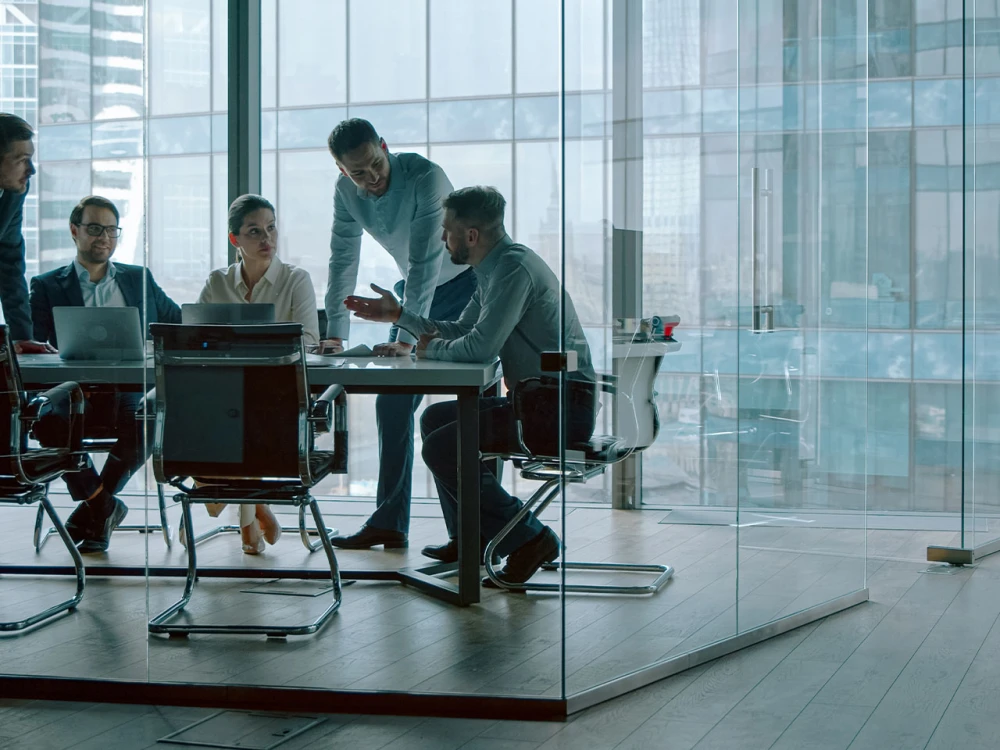 Business team in a meeting in a modern office with glass walls