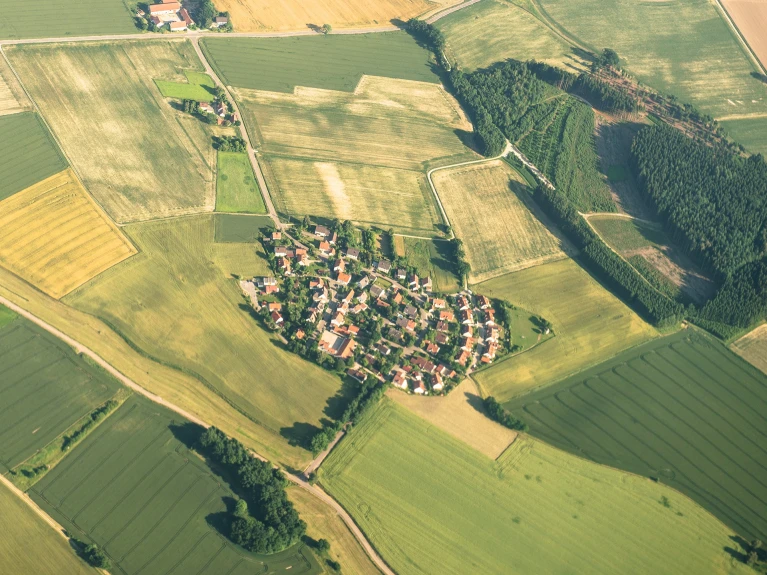 Aerial view of a small village surrounded by agricultural fields