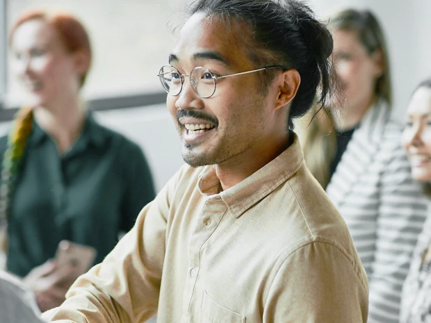Group of smiling people of diverse backgrounds in an office
