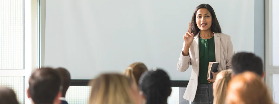 A teacher explaining something in front of a class
